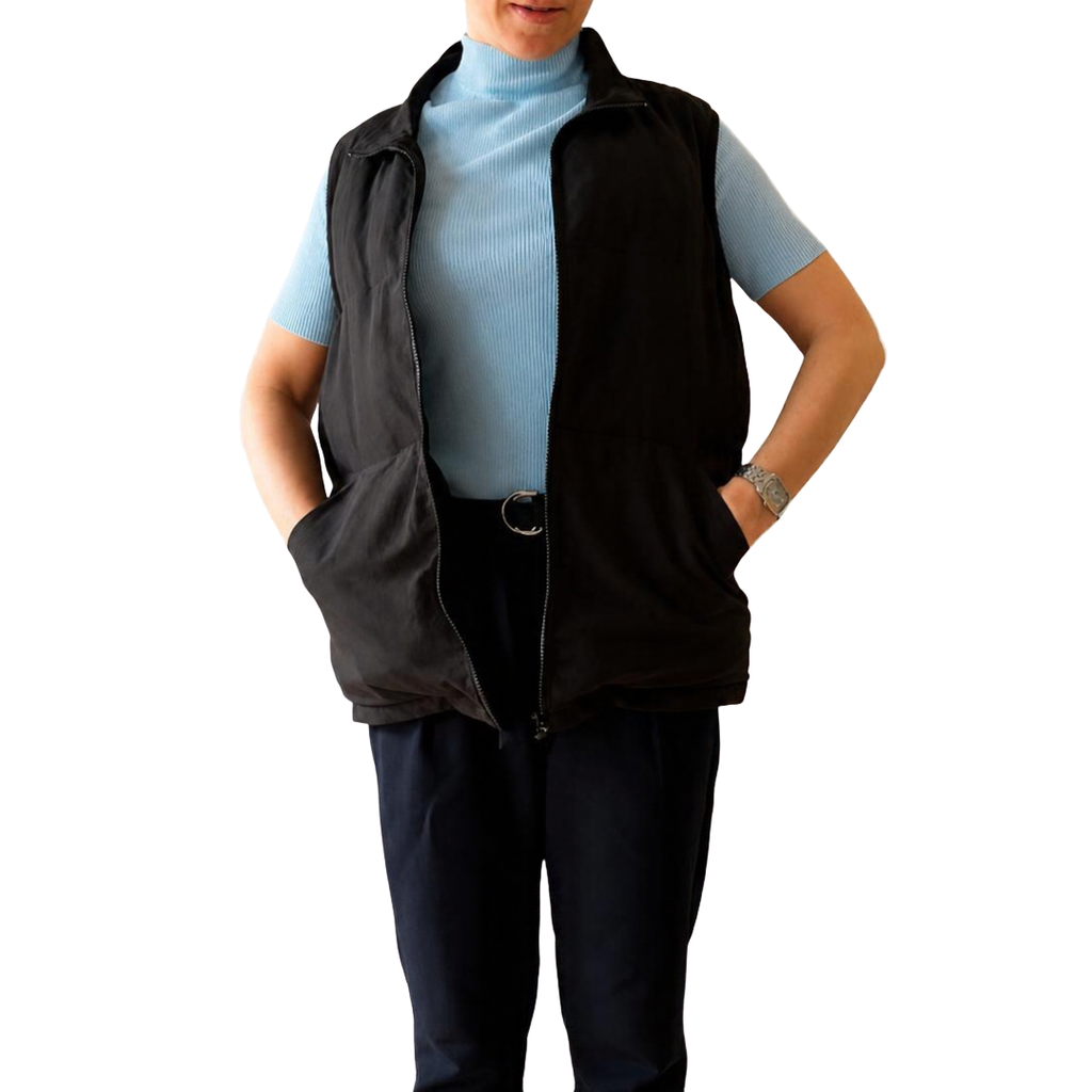 Model wearing the black Cabin Vest with hands in the side pockets, front view